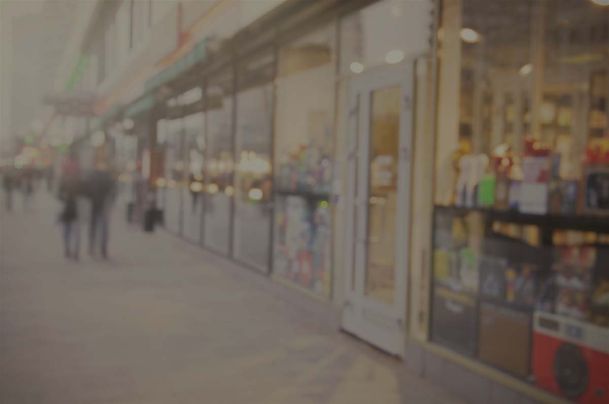 row of retail businesses, many closed or closing.