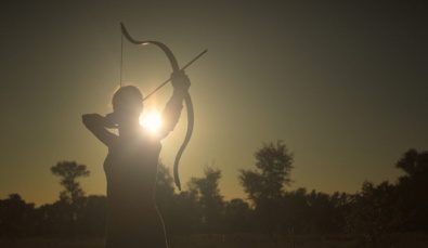 Female Archer In The Field At Sunset