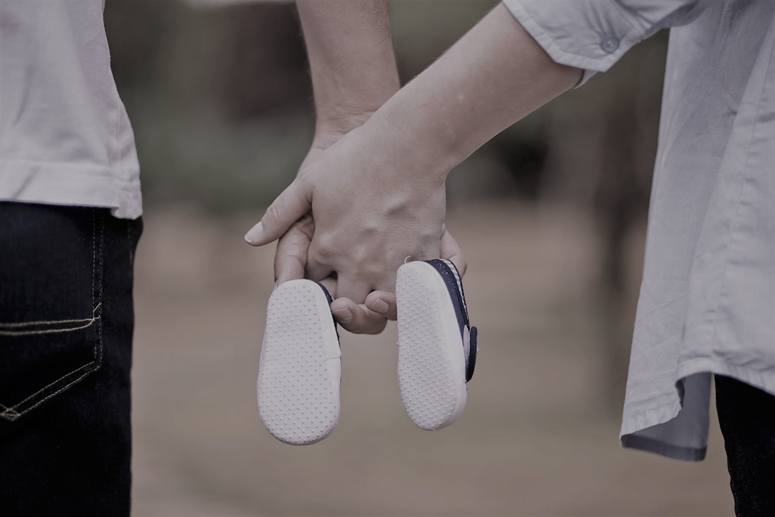 hands linked together with baby shoes | wealth management strategies by MGI