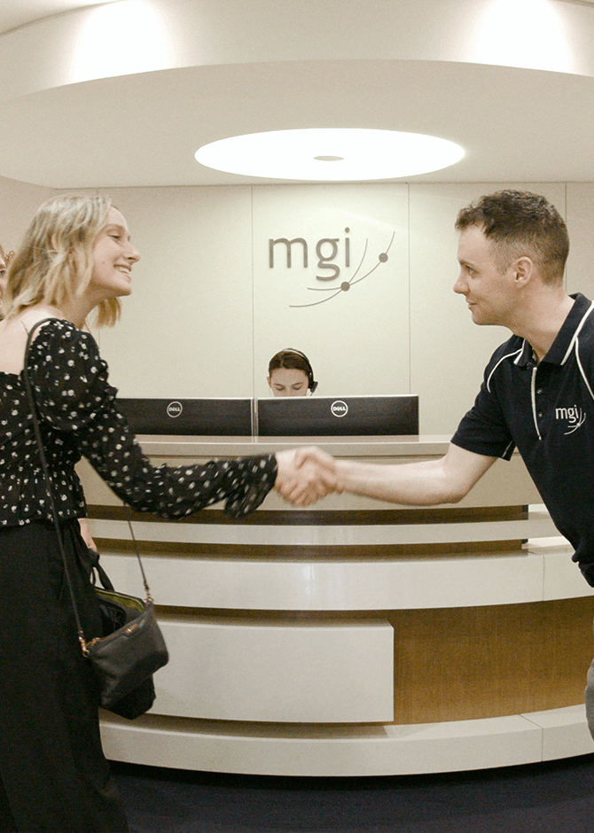 a brisbane business accountant greeting a client at the MGI reception