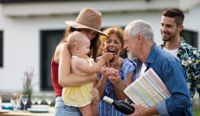 three generations of a family including grandparents, parents and a baby at a outdoor family gathering used on a blog about estate planning