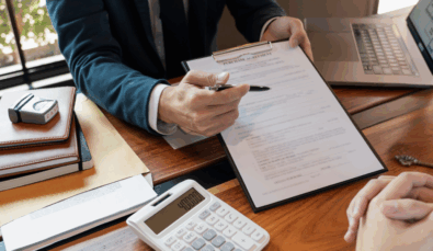 hands using a pen to indicate areas on a form that need to be completed used on a blog about Div 7a and Div 7a loan requirements