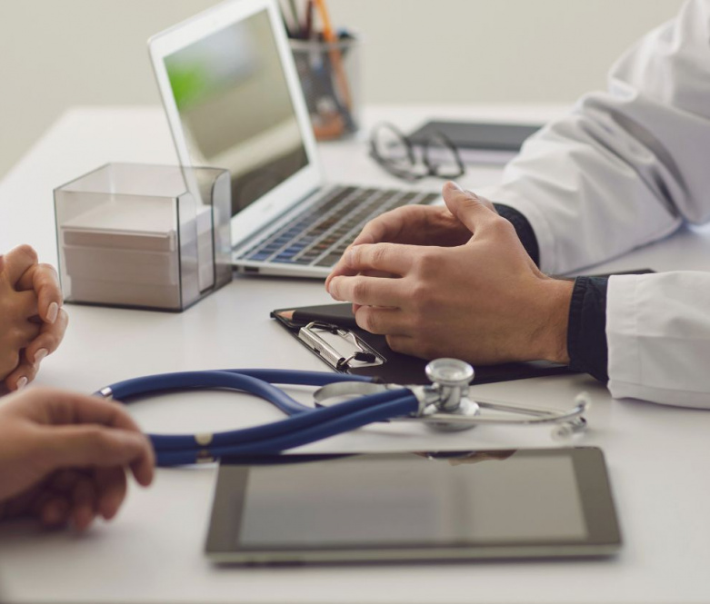 a doctor who's face is out of the frame consulting with a patient used on a page about MGI being specialist accountants for doctors